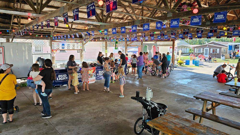 Kids trying on bikes and helmets at the bike giveaway