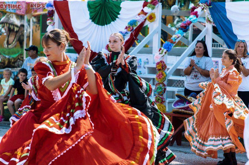 Dance troupe performing a clapping routine at the main stage