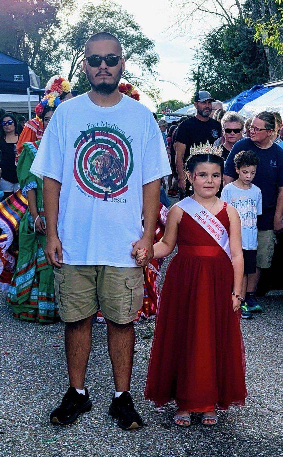 Fiesta-goers at the street parade, one wearing a Junior American Princess sash