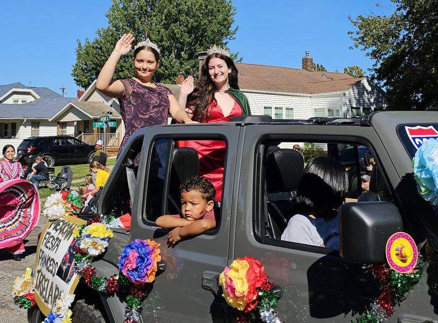 American Fiesta Princess candidates waving from a Jeep in the parade