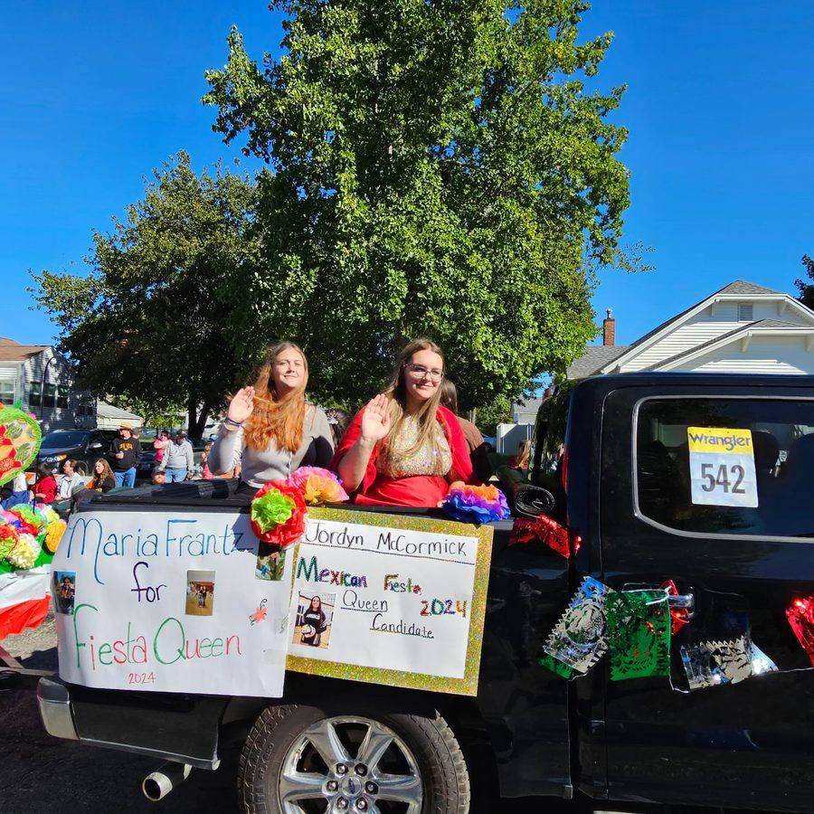 2024 Fiesta Queen candidates waving from a parade float