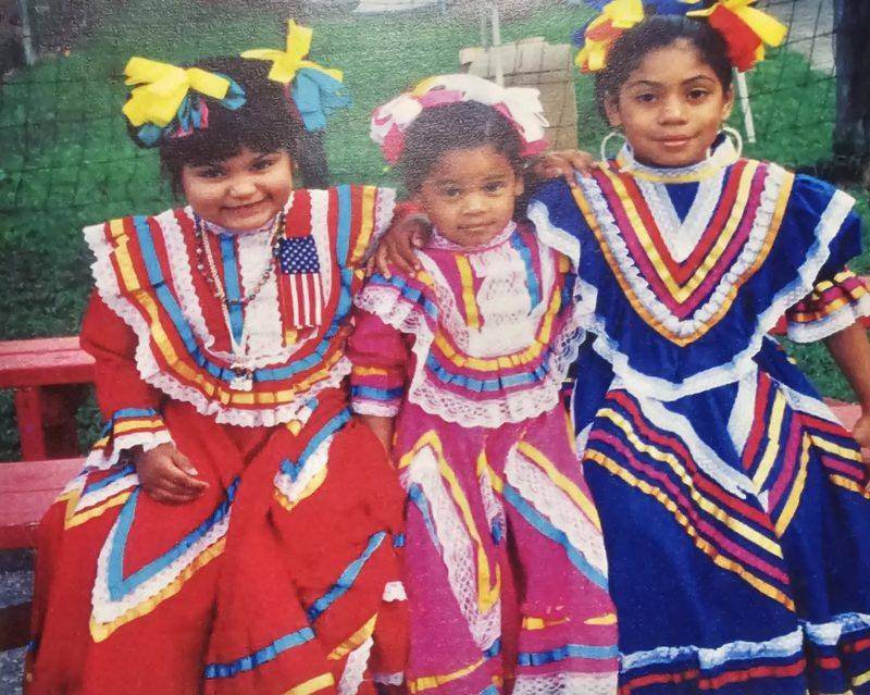 Three children in traditional folklorico dresses