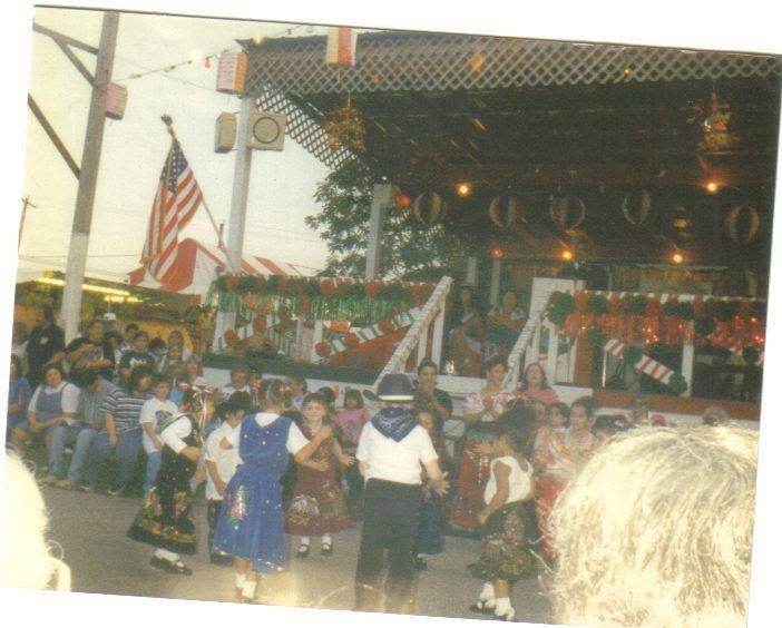 Vintage photo of children dancing in front of the decorated stage